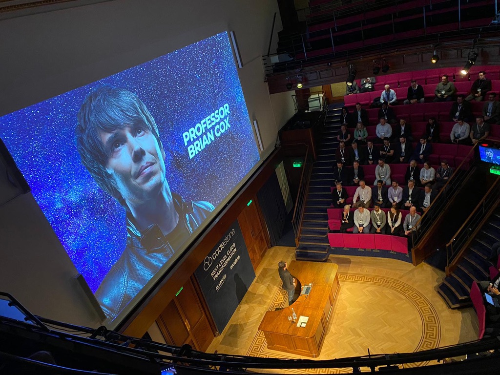 Codestone Customer Day 2022 in the lecture theatre at The Royal Institution, London, with the keynote slide for Professor Brian Cox on screen